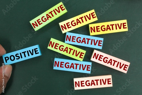 colored paper with positive and negative words. hands choose positive. the concept of attitude. behavioral concept