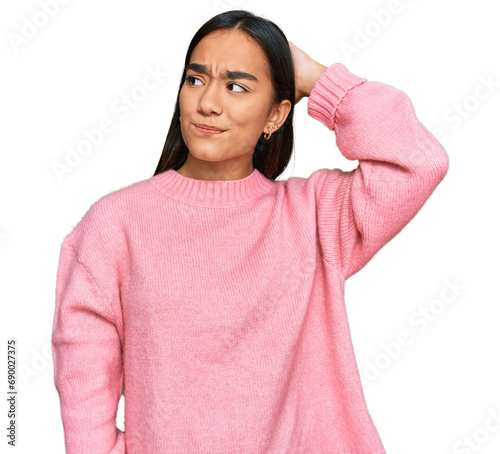 Young asian woman wearing casual winter sweater confuse and wondering about question. uncertain with doubt, thinking with hand on head. pensive concept. © Krakenimages.com