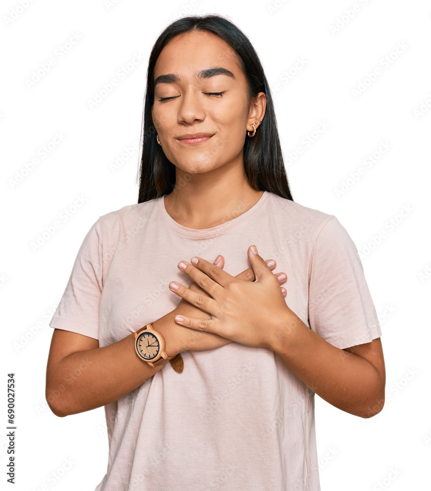Young asian woman wearing casual clothes smiling with hands on chest with closed eyes and grateful gesture on face. health concept. Young asian woman wearing casual clothes smiling with hands on chest with closed eyes and grateful gesture on face. health concept.
