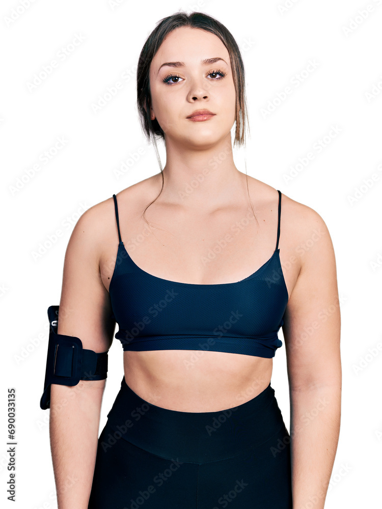 Young hispanic woman wearing sportswear relaxed with serious expression on face. simple and natural looking at the camera.