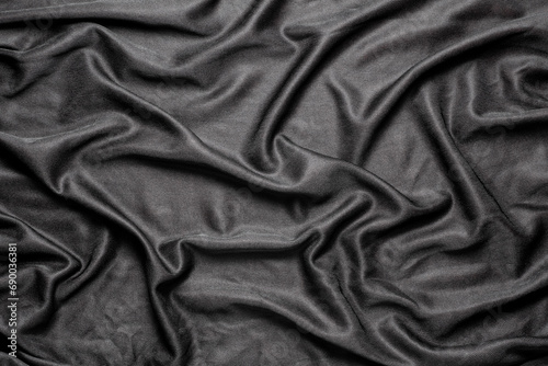 black cloth fabric in soft folds, top view