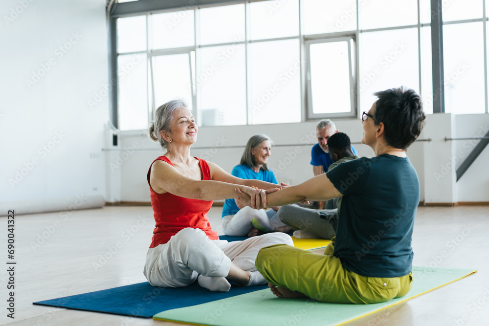 Fellows uniting in pairs to do couple exercises on mats Fellows uniting in pairs to do couple exercises on mats