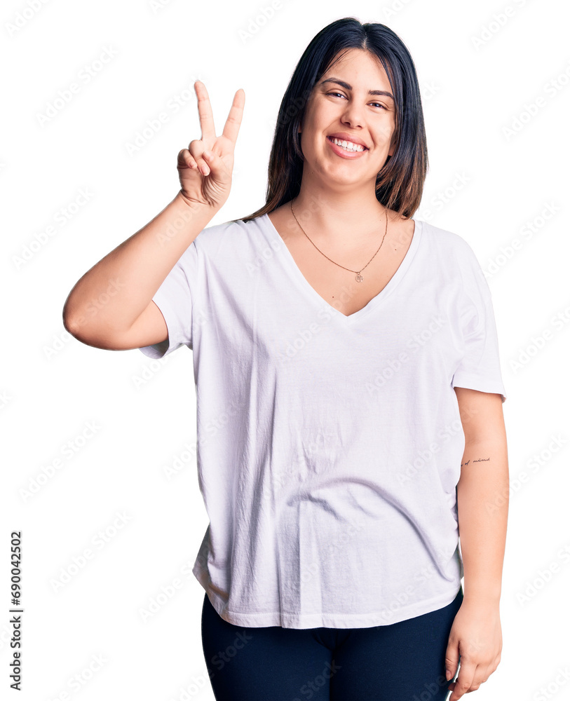 Young beautiful brunette woman wearing casual t-shirt showing and pointing up with fingers number two while smiling confident and happy. Young beautiful brunette woman wearing casual t-shirt showing and pointing up with fingers number two while smiling confident and happy.
