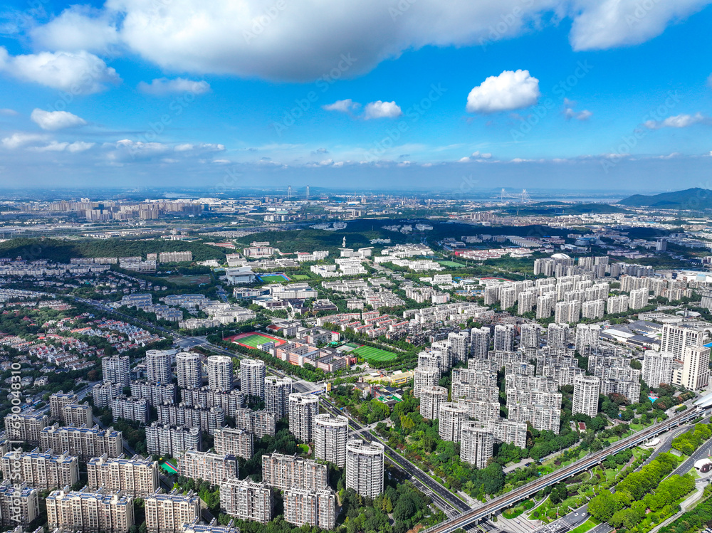 Fototapeta premium Aerial photography of green city, urban buildings, livable environment, blue sky and white clouds