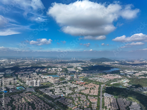 Aerial photography of green city, urban buildings, livable environment, blue sky and white clouds