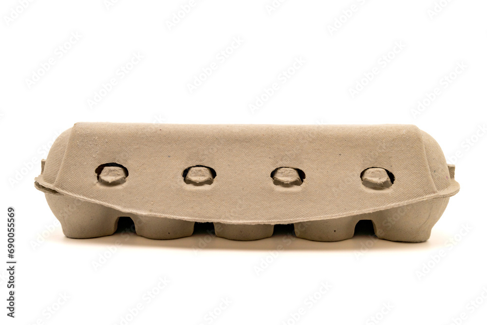 Closed egg box for ten eggs, isolated on white with copy space. Carton pack, egg-container for packaging. Side view, close-up. Closed egg box for ten eggs, isolated on white with copy space. Carton pack, egg-container for packaging. Side view, close-up.