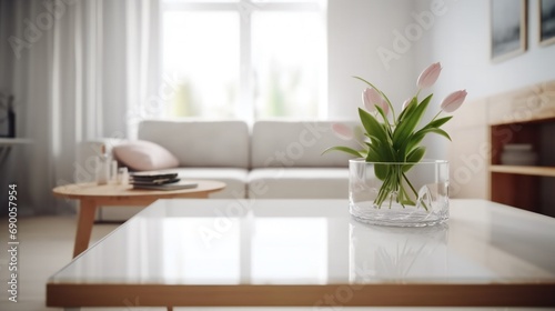 Empty table in bright room. White table With flowers. Bright interior with empty tale.