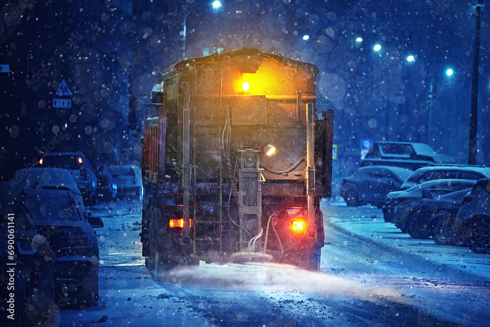 Obraz Truck spread salt on road, melt ice and snow on slippery road at