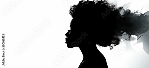 a silhouette of a woman with an afro hair style photo