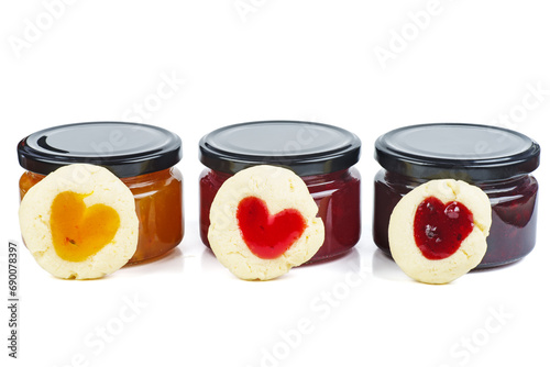 Three colored jam in glass jare with homemade cookies shaped hearts photo