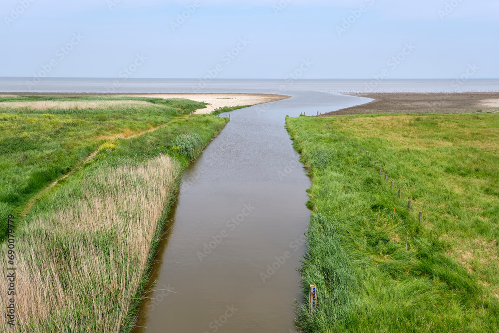 View on the Wadden Sea near Zwarte Haan in the Netherlands on a sunny day with blue sky in summer