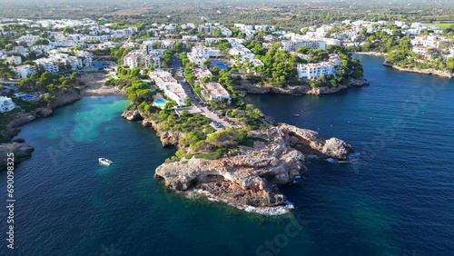 Tropical paradise turquoise bay. Beautiful Mediterranean cave rocky sandy beach with blue water on a sunny day in Majorca, Spain. Famous tourist attraction Cala d'Or Beach, Mallorca, Balearic Islands