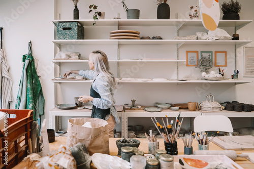 Obraz na plátně Woman creating clay product on ceramics workshop in art studio