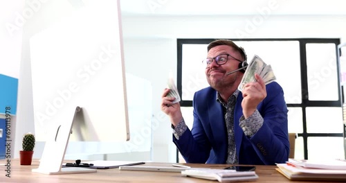 Businessman in headphones deceiving customers and throwing money at screen 4k movie. Economic financial pyramid concept photo