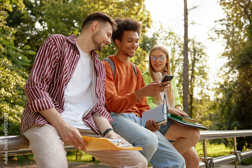 Fotografie Casual teenage students laughing and sharing good mood