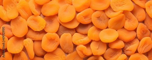 Dried apricots are orange in color. Dried apricots for the background. Top view.