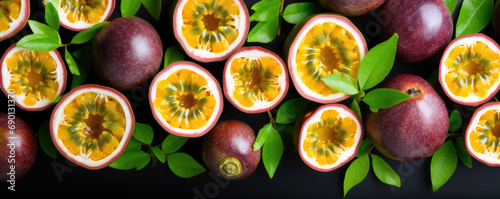 Close-up of fresh purple passion fruit harvest with leaves. View from above.