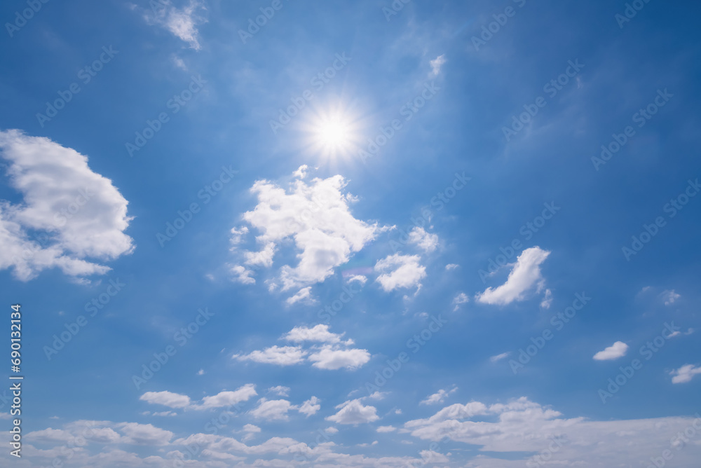 Obraz premium Panoramic view of clear blue sky and clouds, Blue sky background with tiny clouds. White fluffy clouds in the blue sky. Captivating stock photo featuring the mesmerizing beauty of the sky and clouds.