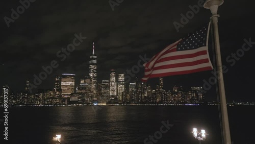 USA flag in night NYC. Memorial Day, Veteran's Day, 4th of July. American Flag Waving near New York City, Manhattan view. Independence Day. Labor, Flag, Patriots, President Day.