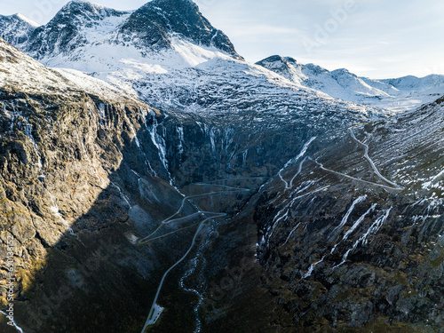 aerial view from drone of winding road trolls ladder trolstigen during winter with snow in mountains photo