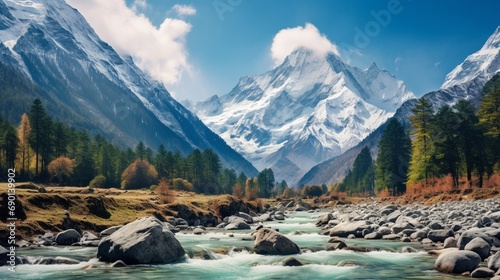 A landscape of river with stones on its path. Pine trees and snow capped mountain in the background