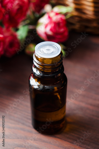 Small bottle with essential oil. Aromatherapy and herbal medicine concept. Selective focus. Wooden background.