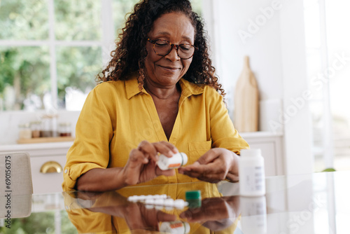 Senior woman taking prescription medication at home