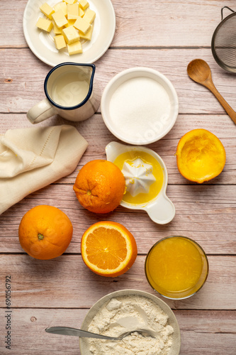 Squeezed orange fruit juice, ingredients for cooking, baking orange cake, sugar, flour, milk, copy space