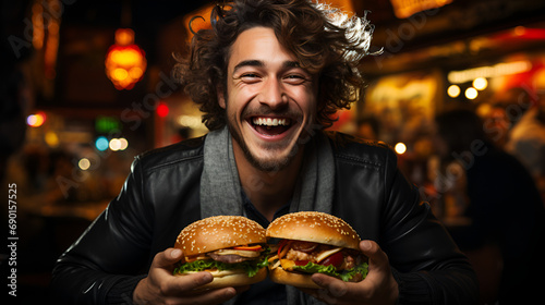 man holding two burgers and smiling