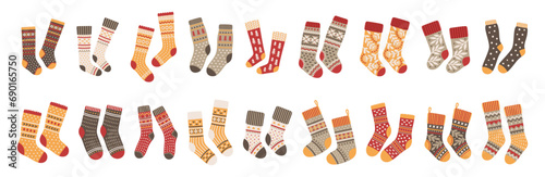 Vector pairs of socks icons set. Illustration of cute knitted accessories with Christmas ornaments. Colorful clothes for men, women, and babies.