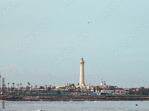 view of The El Hank lighthouse  seen from Hassan II Mosque Park , it is a lighthouse located on the tip of El Hank, west of the port of Casablanca, Morocco © JK2507