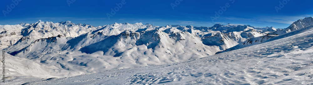 snowy mountain range in the French alps in Tignes resort under blue sky