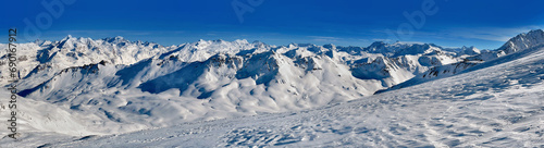 snowy mountain range in the French alps in Tignes resort under blue sky © coco