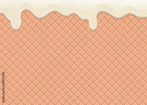 White chocolate flowing down on the waffle background.