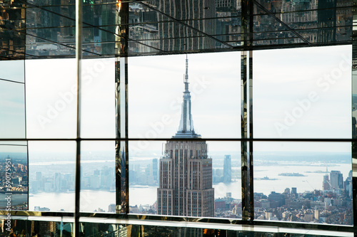 Empire State Through glass of modern skyscraper in city downtown