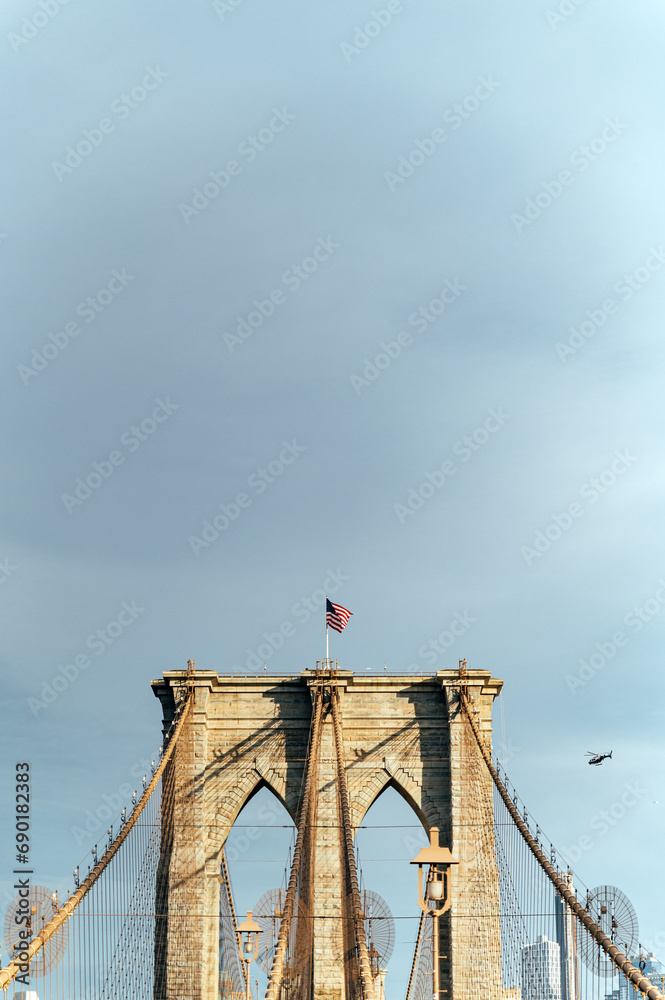 Fototapeta premium Brooklyn Bridge with waving American flag
