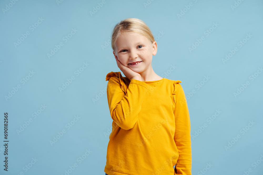 Portrait of smiling cute little girl smiling, wearing casual clothes, fashion model posing Portrait of smiling cute little girl smiling, wearing casual clothes, fashion model posing