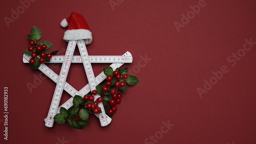 Santa's hat on the folding rule. Christmas and New Year concept for construction companies