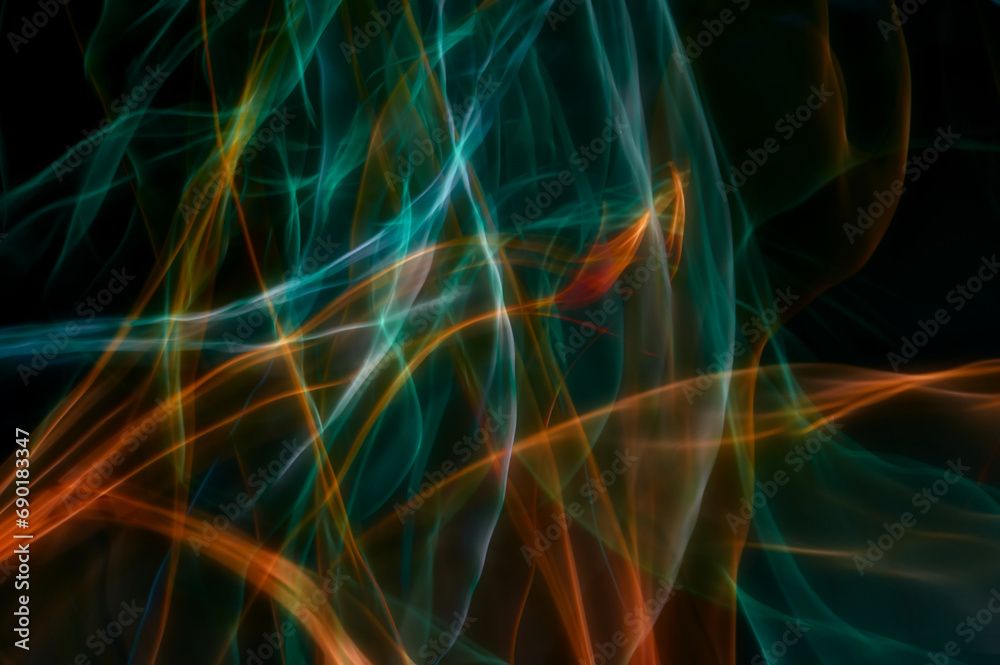 Fiery lines and cold stripes, contrast of colors on a black background, abstract photography, created using intentional camera movements