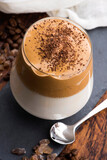 Dalgona coffee in glass cup. Korean trendy drink from instant coffee, milk and brown sugar