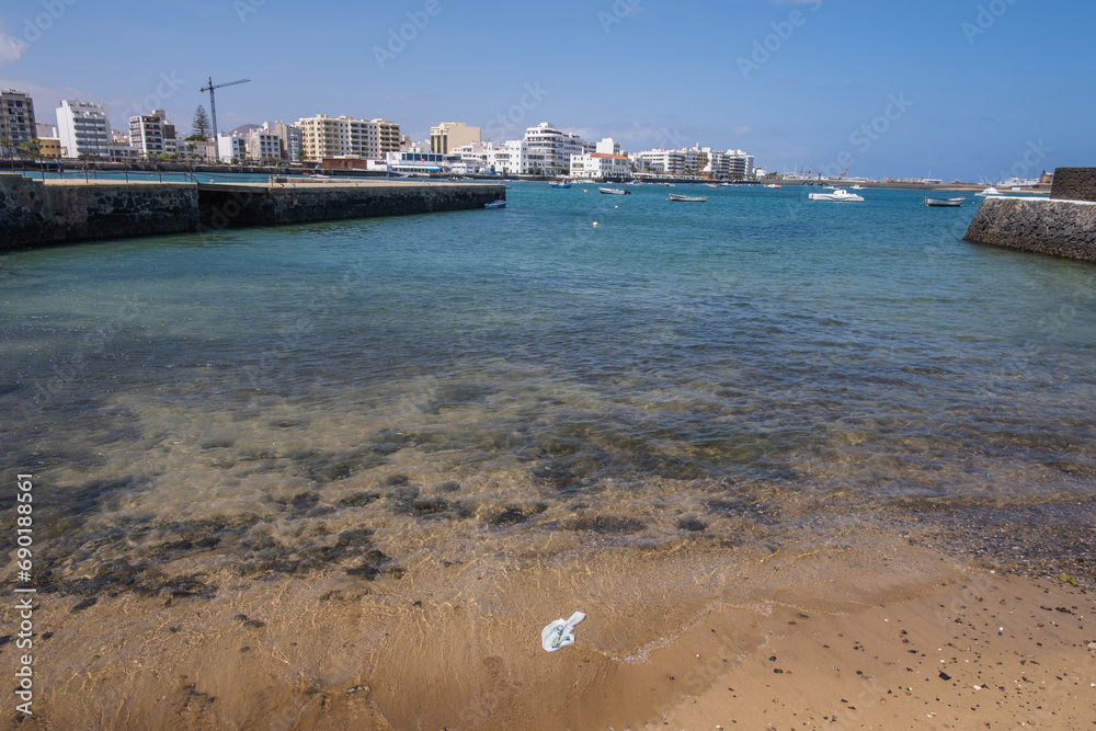 arrecife sightseeing, arrecife lanzarote, downtown, Seascape. View of the city of Arrecife from the islet. White sand beach and jetty. Lanzarote, Canary Islands, Spain.