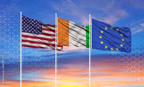 flags of European Union, United States and Côte d'Ivoire on flagpoles and blue sky