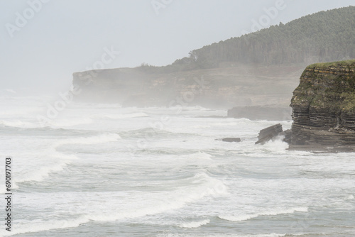Strong waves breaking on the cliffs of Galizano in Cantabria photo