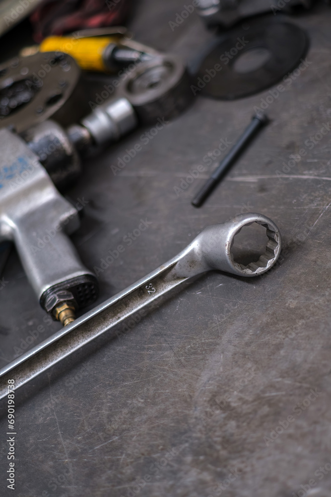 Industrial hand tool, parts and hand tools lying on the metal stand in the factory. Industrial hand tool, parts and hand tools lying on the metal stand in the factory.