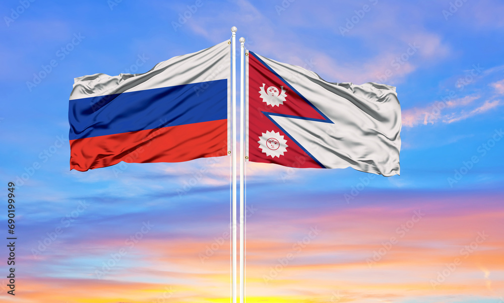 Russia and Nepal two flags on flagpoles and blue sky.