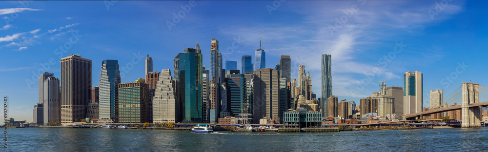 Panorama view of New York City featuring city skyline Manhattan midtown business district office buildings near Brooklyn Bridge