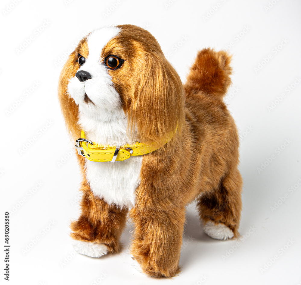 A beautiful children's toy dog of the spaniel breed on a white background. A beautiful children's toy dog of the spaniel breed on a white background.