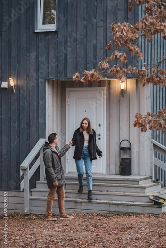 Young stylish couple walking down the stairs of their barn style home
