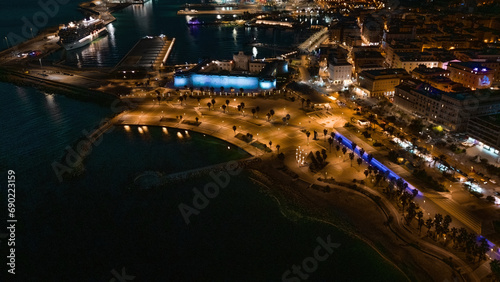 Aerial night background of Civitavecchia panorama. port edge with Fort Michelangelo and golden sand.