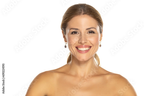 A portrait of a joyful woman with a beautiful smile and tasteful makeup,posing on white background, expressing happiness and confidence